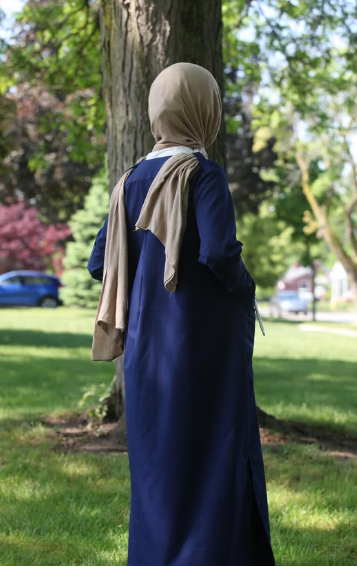 Healthcare professional in modest navy attire